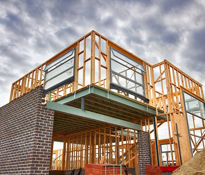 A building under construction with wood framing.