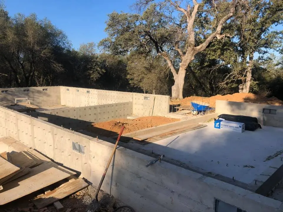 A concrete slab being poured for the foundation of a house.