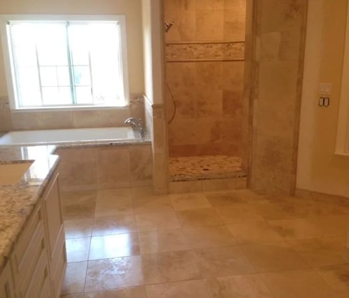 A bathroom with marble floors and walls.