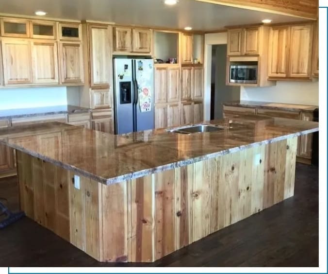 A kitchen with wooden cabinets and granite counter tops.