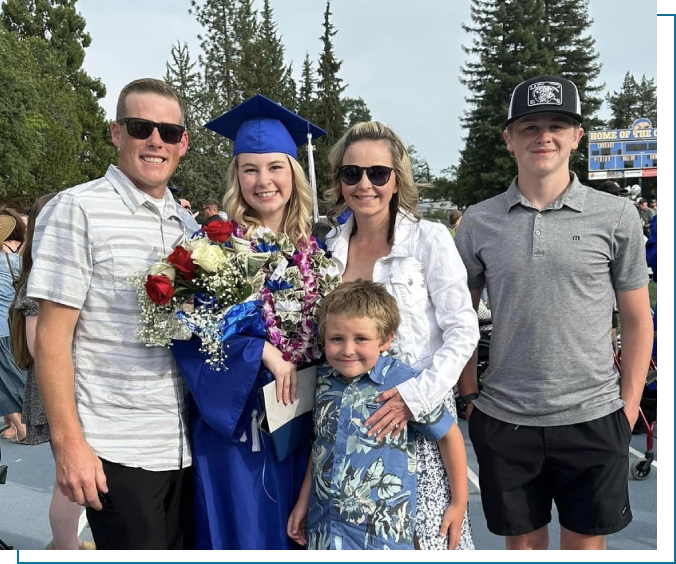 A family posing for a picture with a graduate.