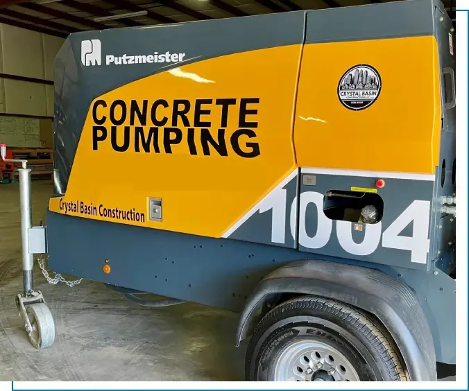 A concrete pump truck parked in a garage.